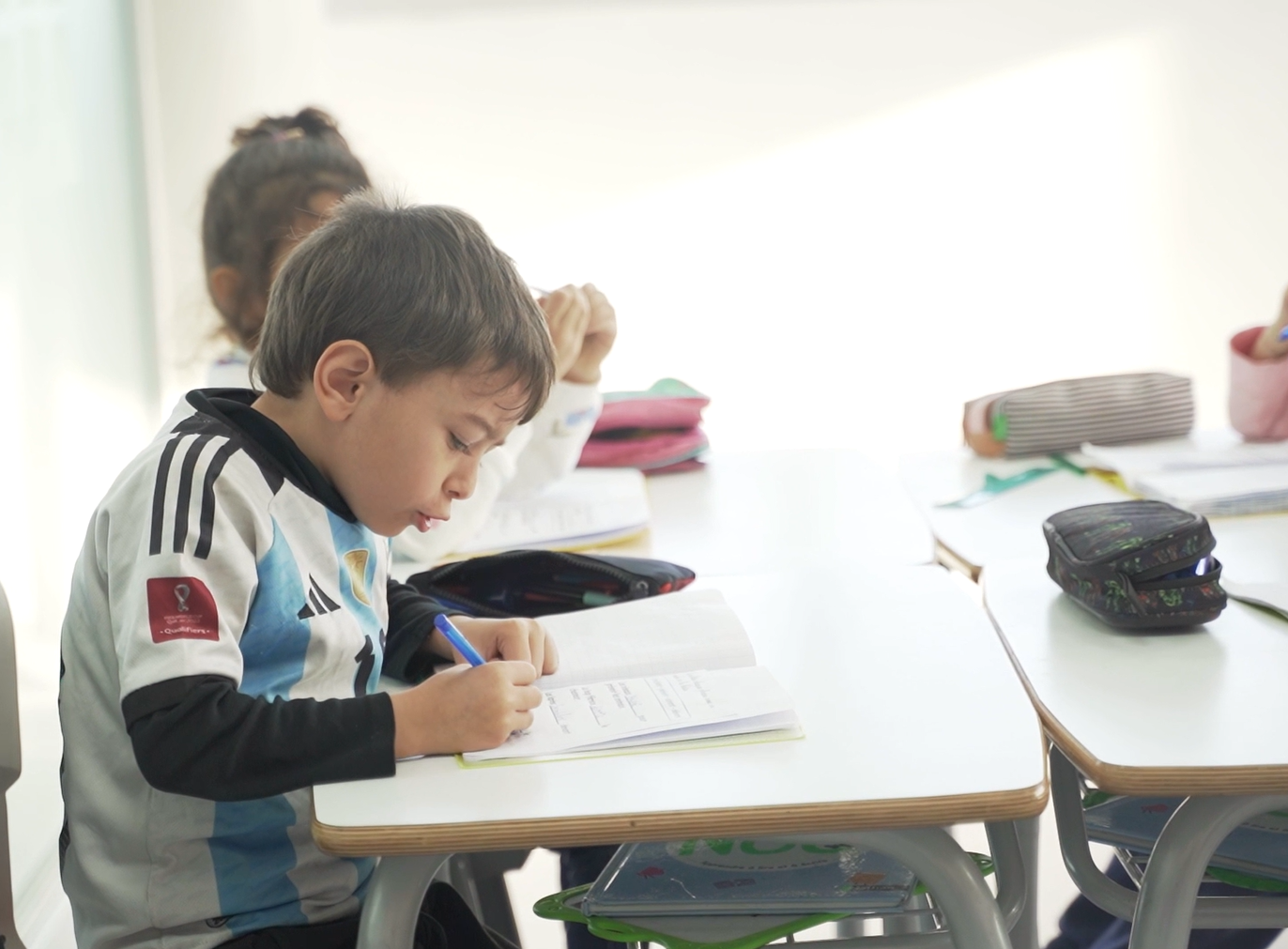 Élève apprenant l'écriture en classe à ED School